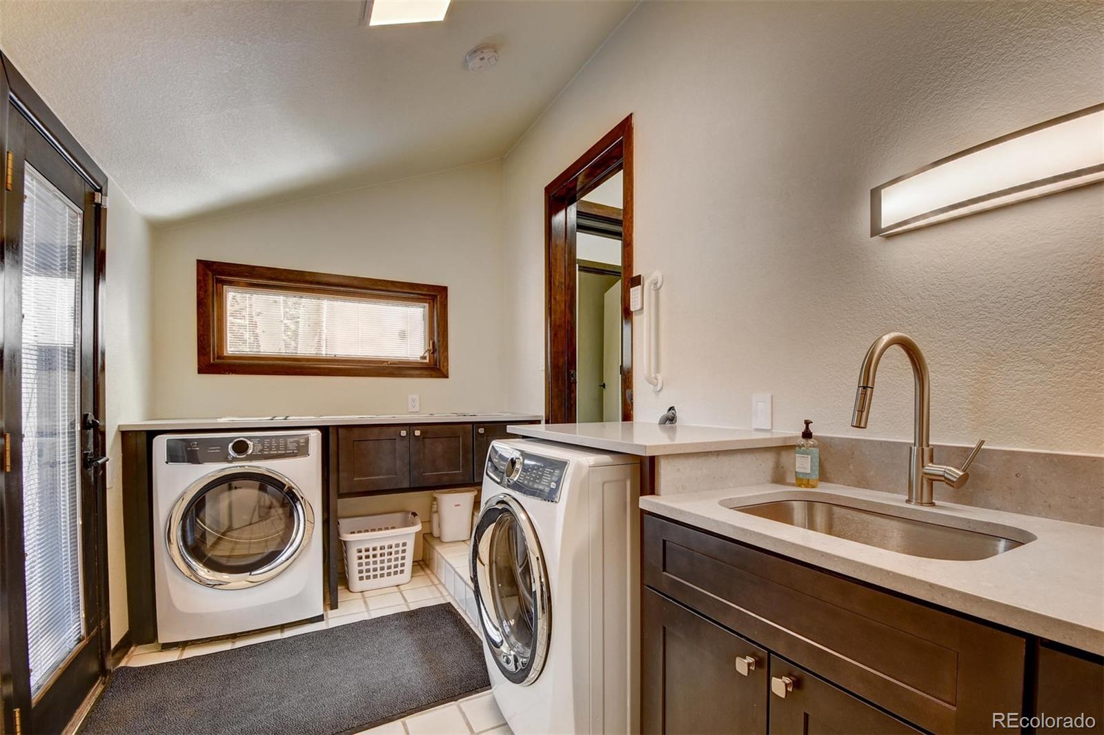 574 Spring Ranch Drive Golden, CO 80401 - Photo 25 of 40 a utility room with sink dryer and washer