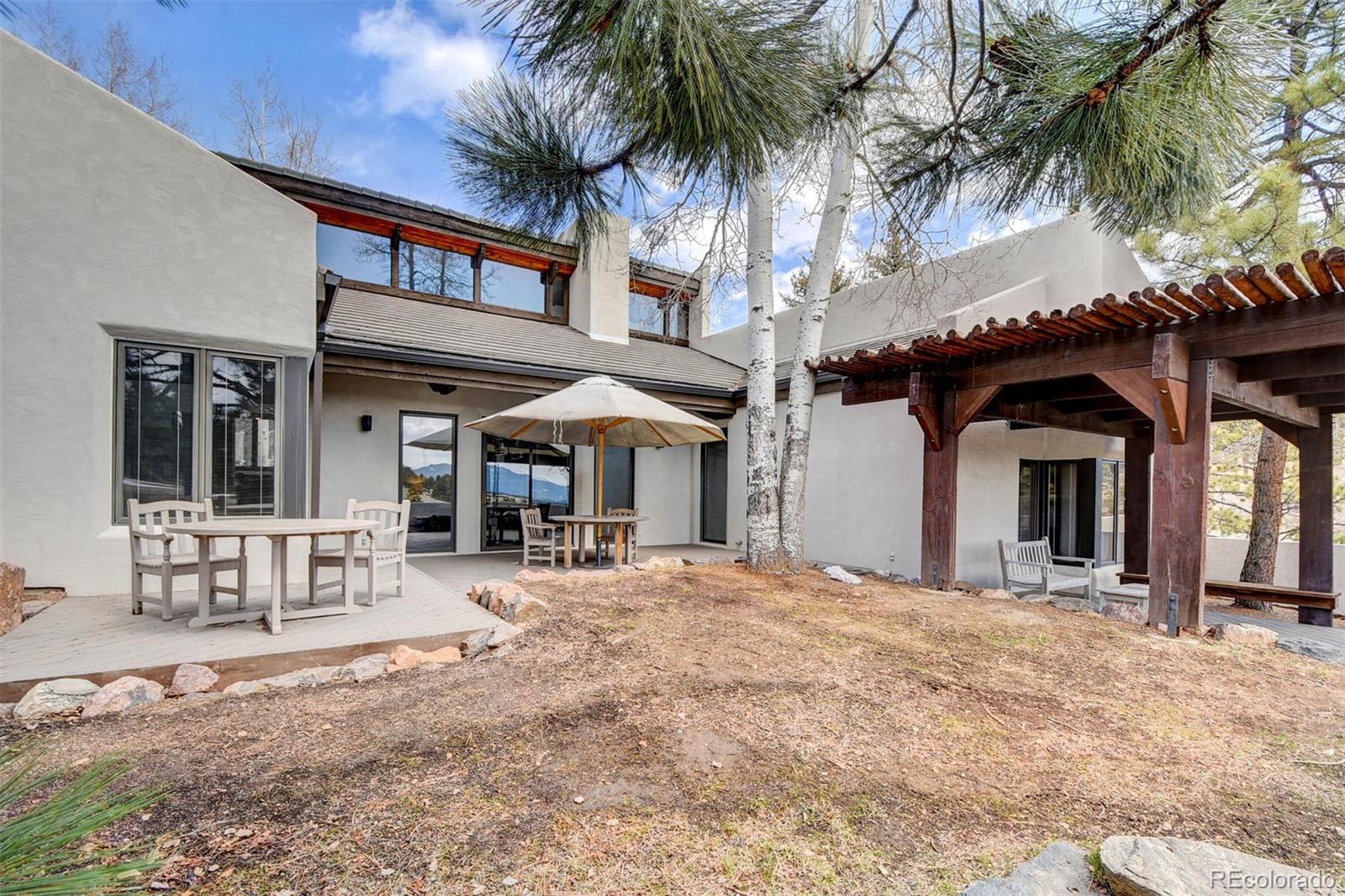 574 Spring Ranch Drive Golden, CO 80401 - Photo 26 of 40 a front view of a house with a garden and patio