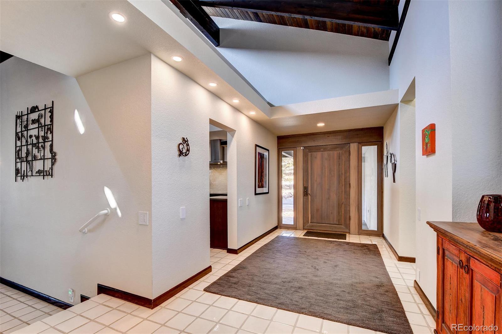 574 Spring Ranch Drive Golden, CO 80401 - Photo 3 of 40 a view of a hallway with closet and wooden floor