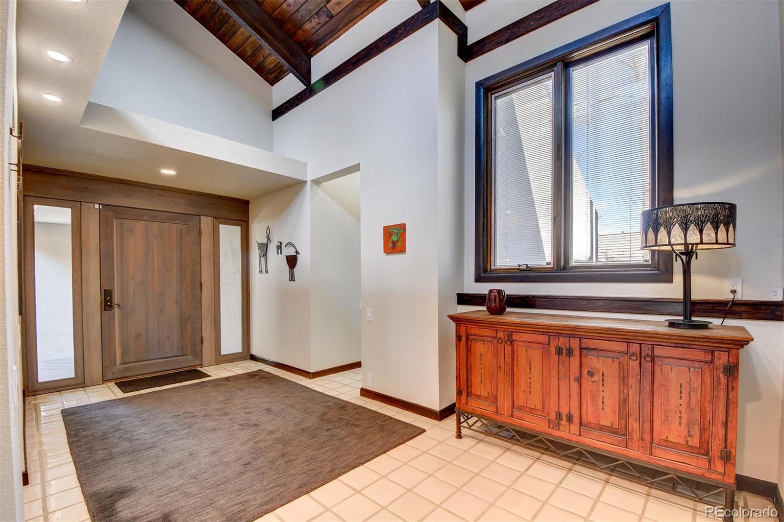 574 Spring Ranch Drive Golden, CO 80401 - Photo 4 of 40 a view of a hallway with two windows and chandelier
