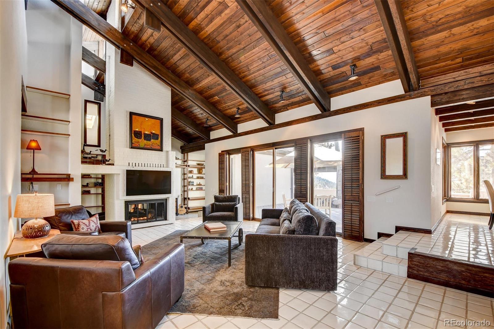 574 Spring Ranch Drive Golden, CO 80401 - Photo 5 of 40 a living room with furniture a fireplace and a large window