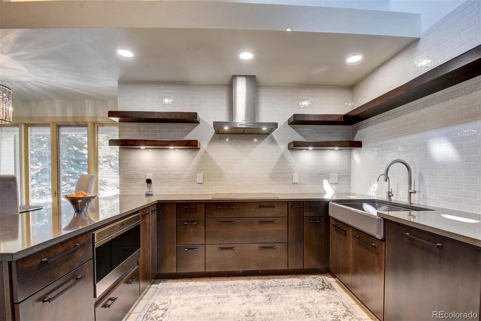 574 Spring Ranch Drive Golden, CO 80401 - Photo 10 of 40 a kitchen with a sink and wooden cabinets