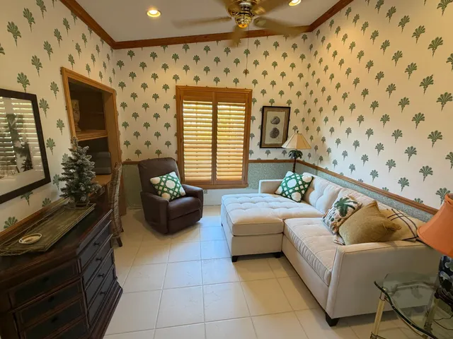 a view of a dining room with furniture a rug and wooden floor