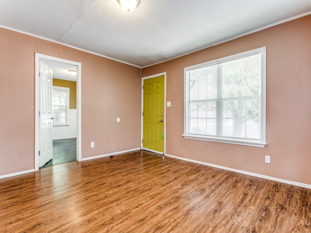 1136 Garland Avenue Austin, TX 78721 - Photo 11 of 24 a view of an empty room with window and wooden floor