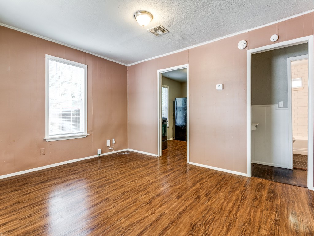 1136 Garland Avenue Austin, TX 78721 - Photo 12 of 24 an empty room with wooden floor and windows