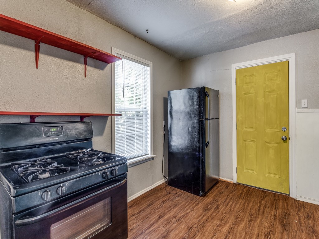 1136 Garland Avenue Austin, TX 78721 - Photo 13 of 24 a kitchen with a stove and a refrigerator