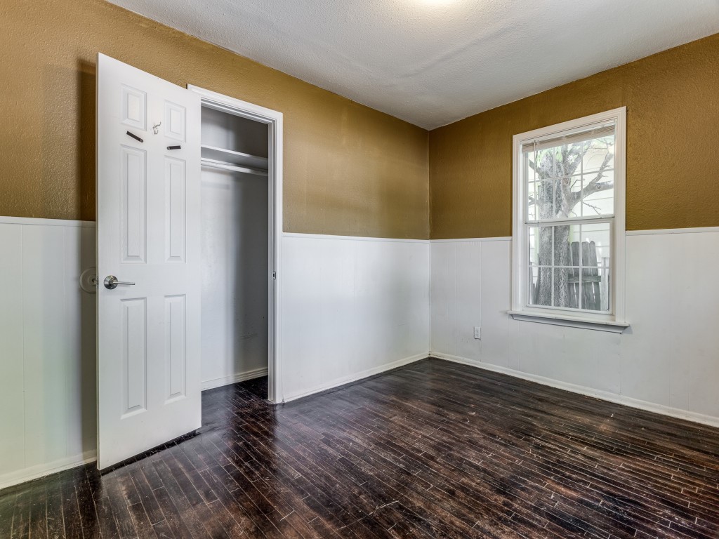 1136 Garland Avenue Austin, TX 78721 - Photo 15 of 24 a view of an empty room with wooden floor and a window