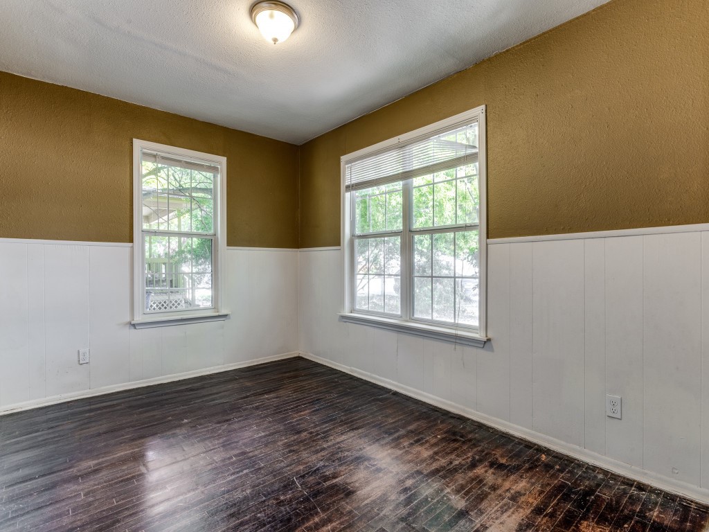 1136 Garland Avenue Austin, TX 78721 - Photo 16 of 24 a view of an empty room with wooden floor and a window