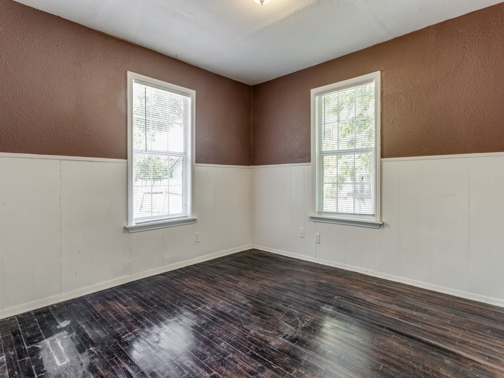 1136 Garland Avenue Austin, TX 78721 - Photo 17 of 24 an empty room with wooden floor and windows