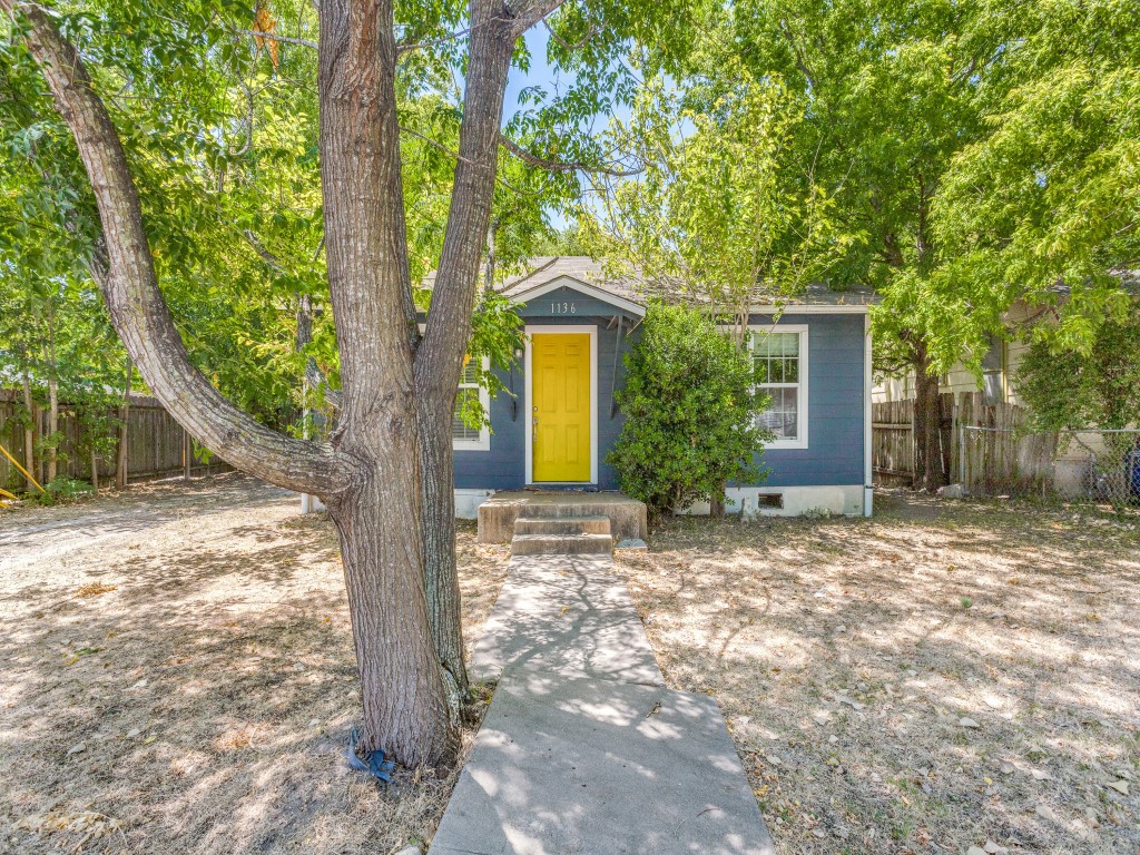 1136 Garland Avenue Austin, TX 78721 - Photo 20 of 24 a front view of a house with a yard and garage