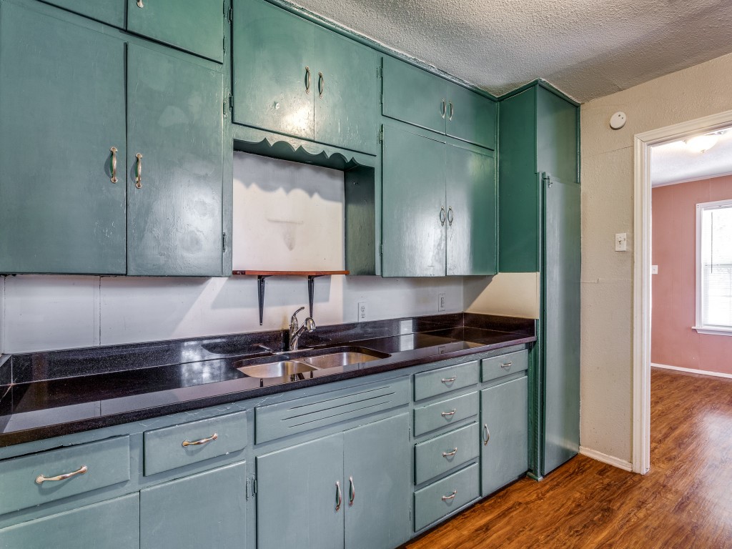 1136 Garland Avenue Austin, TX 78721 - Photo 3 of 24 a kitchen with a sink and cabinets