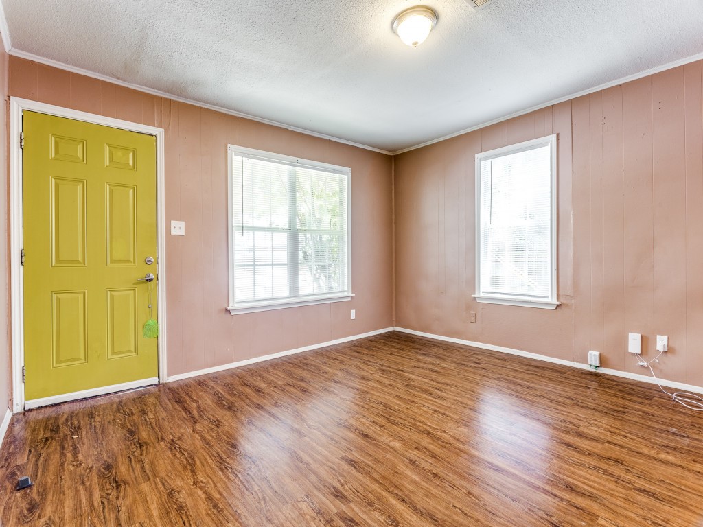 1136 Garland Avenue Austin, TX 78721 - Photo 4 of 24 a view of an empty room with wooden floor and a window