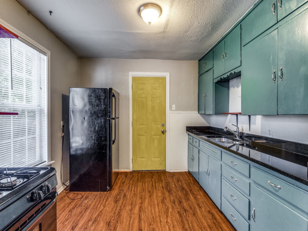1136 Garland Avenue Austin, TX 78721 - Photo 9 of 24 a kitchen with a sink and wooden floor