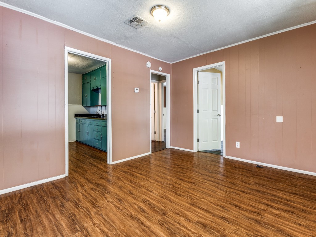 1136 Garland Avenue Austin, TX 78721 - Photo 10 of 24 a view of an empty room with wooden floor and closet