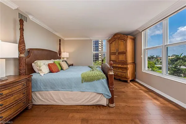 a bed sitting in a bedroom next to a window