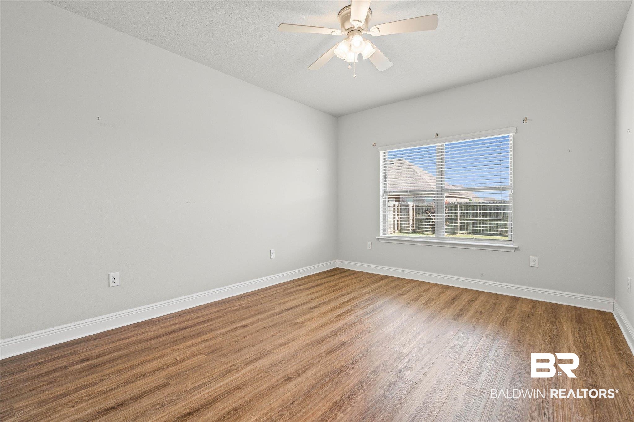 10207 Dunleith Loop Daphne, AL 36526 - Photo 15 of 23 Empty room featuring wood finished floors and ceiling fan
