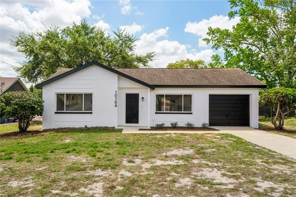 a house with lots of trees in the background