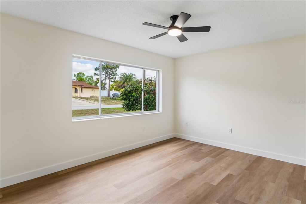 10194 Gamewell Street Spring Hill, FL 34608 - Photo 16 of 36 an empty room with a window and a fan