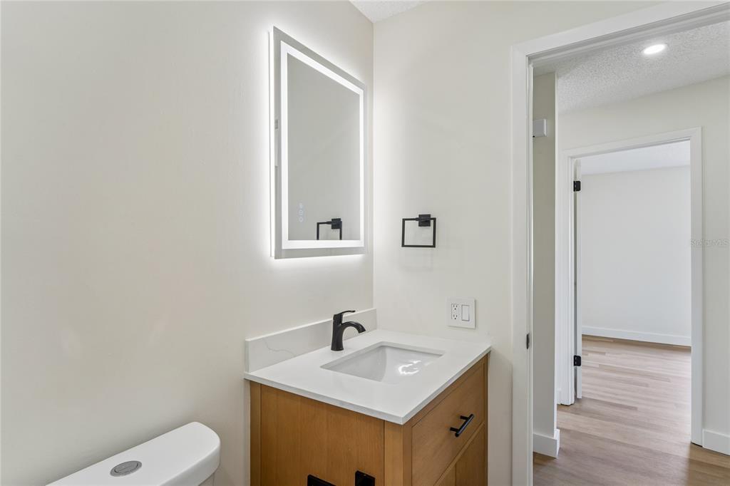 10194 Gamewell Street Spring Hill, FL 34608 - Photo 20 of 36 a bathroom with a sink toilet and vanity