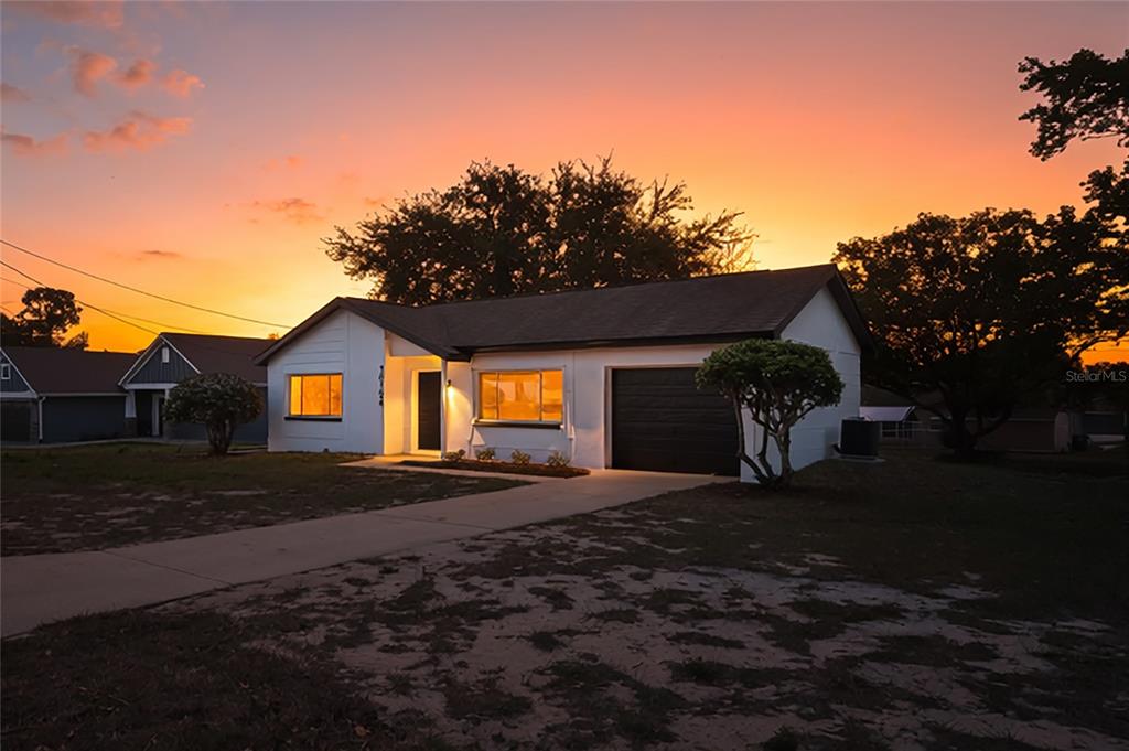 10194 Gamewell Street Spring Hill, FL 34608 - Photo 2 of 36 a front view of a house with a yard and garage