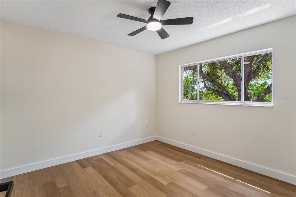 10194 Gamewell Street Spring Hill, FL 34608 - Photo 21 of 36 an empty room with a window and a ceiling fan