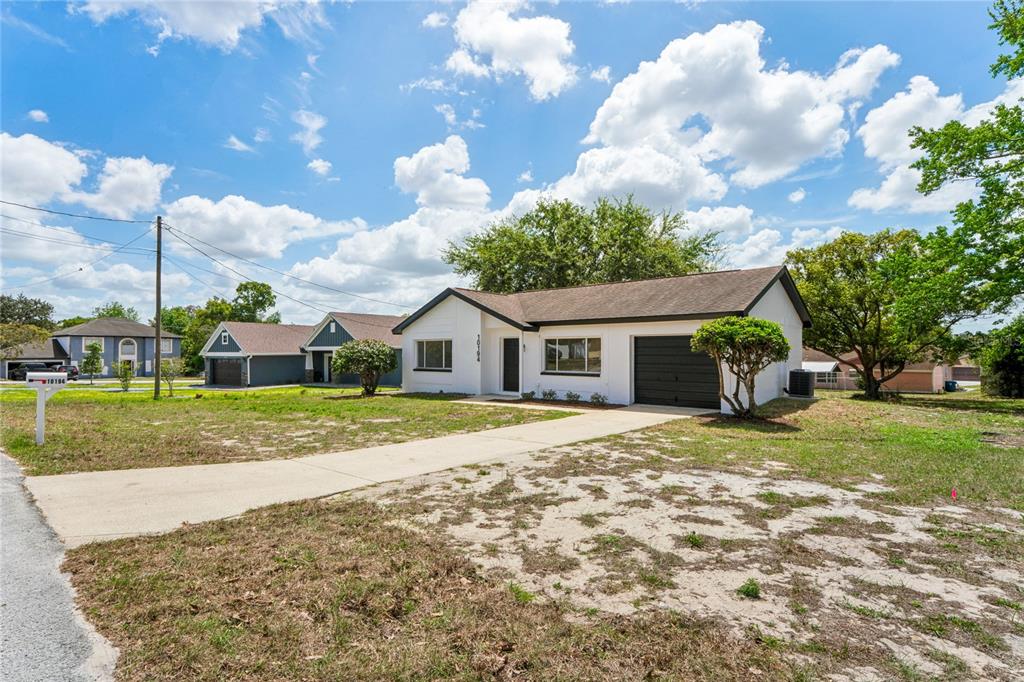 10194 Gamewell Street Spring Hill, FL 34608 - Photo 29 of 36 a front view of a house with garden