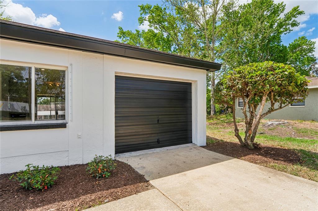 10194 Gamewell Street Spring Hill, FL 34608 - Photo 30 of 36 a couple of potted plants in front of door