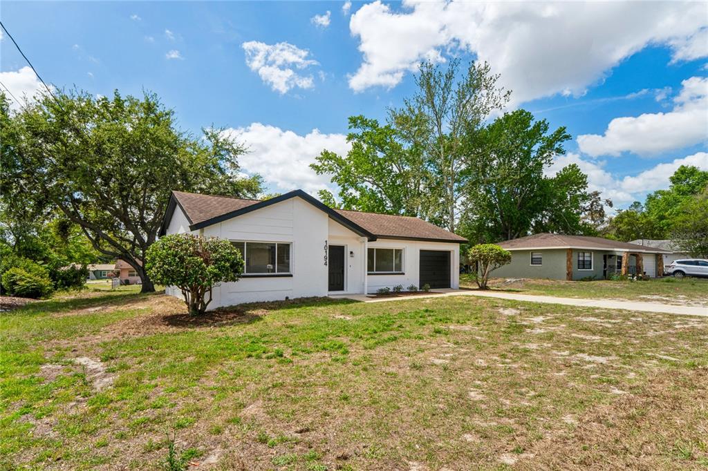 10194 Gamewell Street Spring Hill, FL 34608 - Photo 31 of 36 a view of a house with a yard