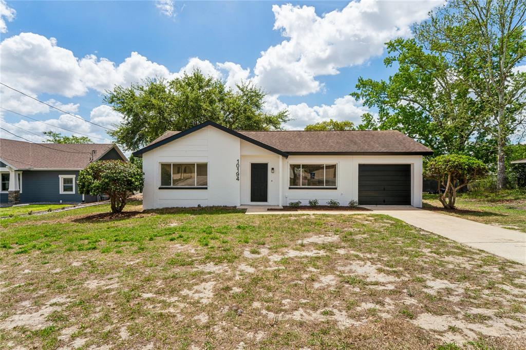 10194 Gamewell Street Spring Hill, FL 34608 - Photo 32 of 36 a view of a house with a yard