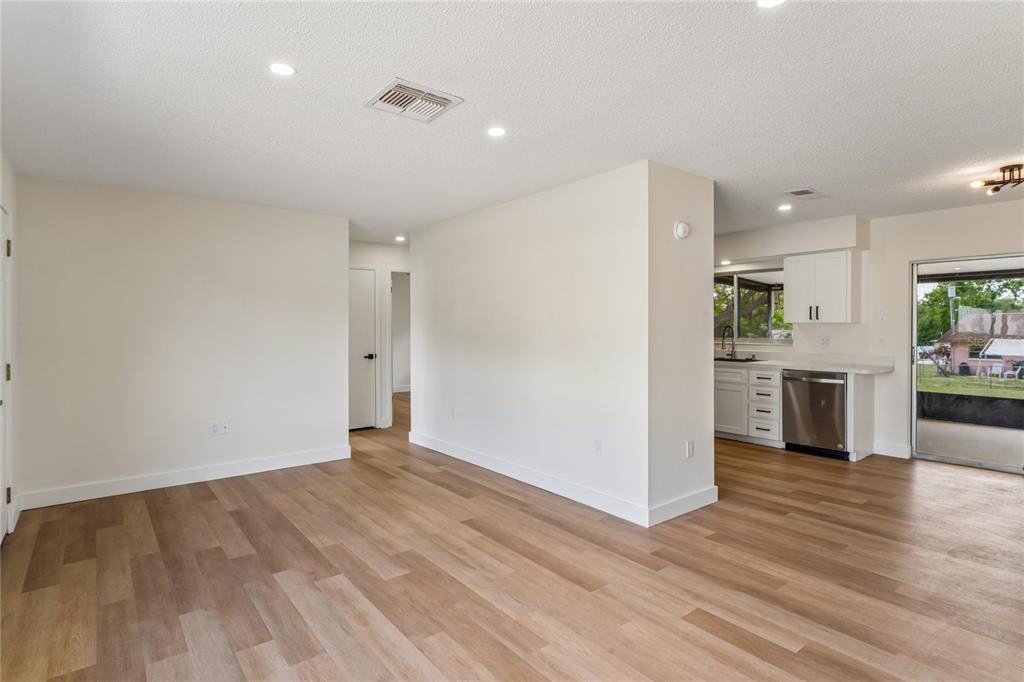 10194 Gamewell Street Spring Hill, FL 34608 - Photo 6 of 36 a view of a kitchen with a sink and a refrigerator