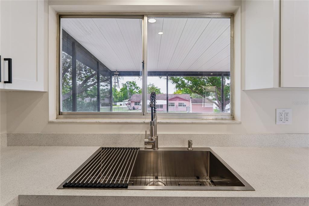 10194 Gamewell Street Spring Hill, FL 34608 - Photo 10 of 36 a kitchen with a sink and a window