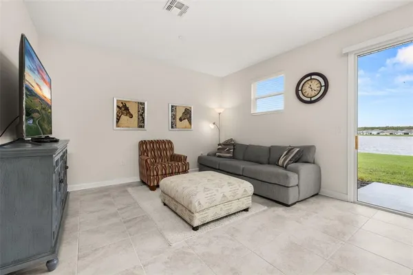 a living room with furniture a rug and a flat screen tv