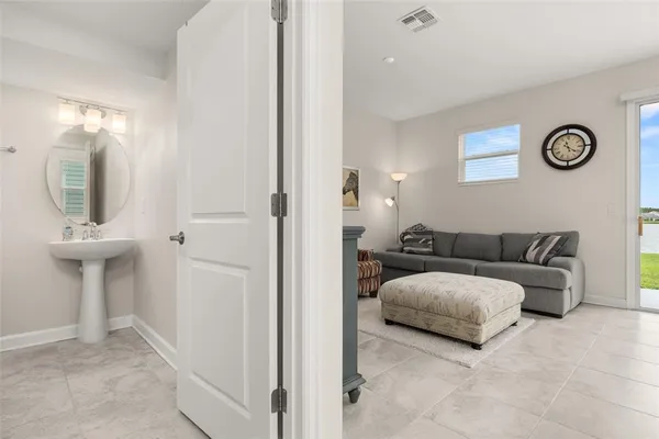 a living room with a couch and a mirror