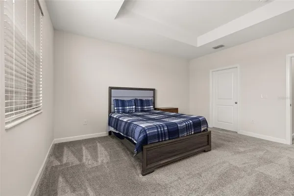 a bed sitting in a room next to a window