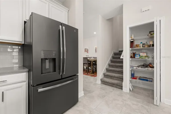 a view of a kitchen with refrigerator and microwave
