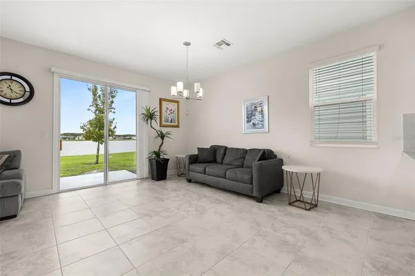 a living room with furniture and a floor to ceiling window