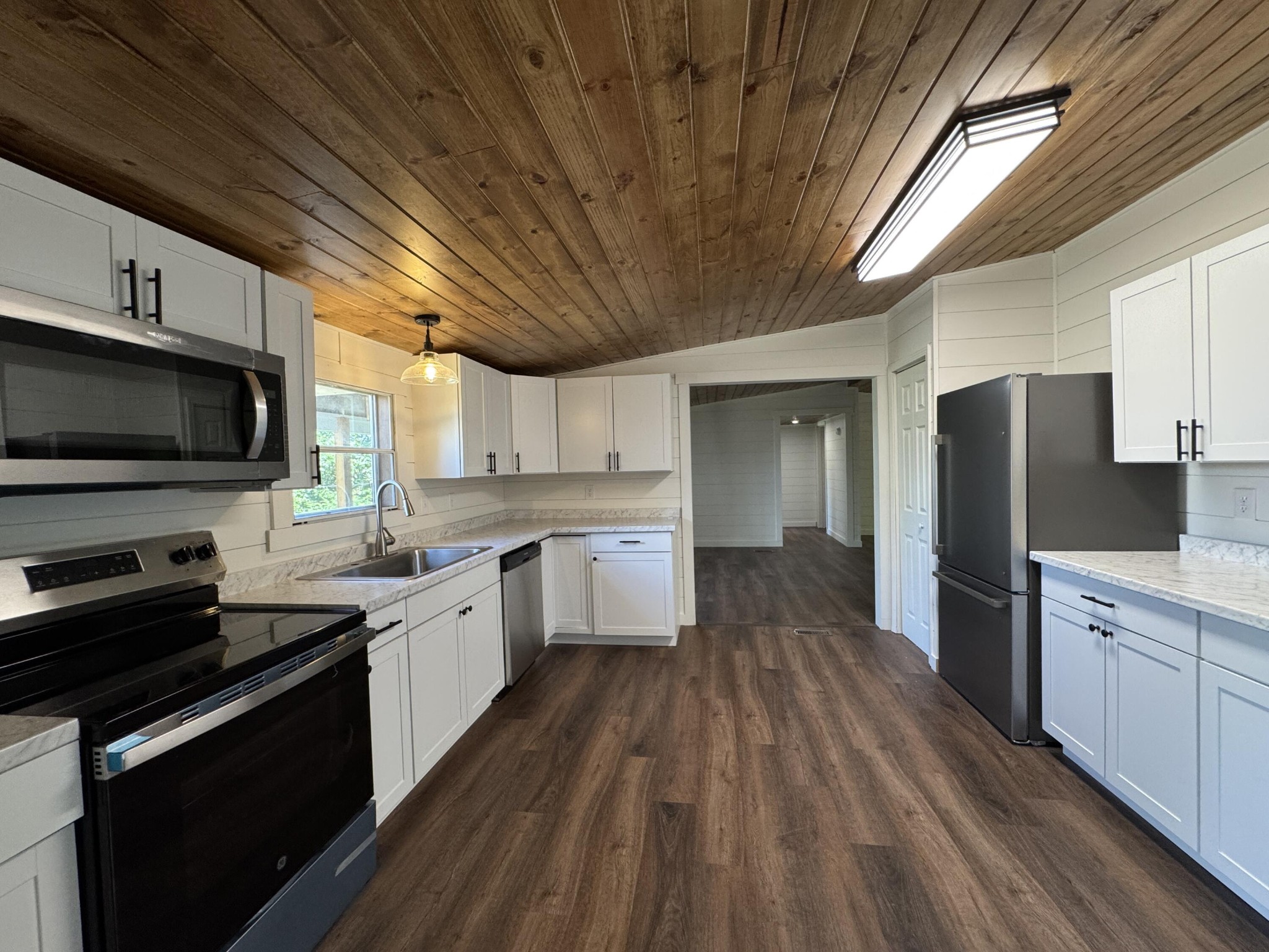 675 Ware Lane Georgetown, TN 37336 - Photo 11 of 24 a large kitchen with a large kitchen island wooden floor stainless steel appliances and cabinets