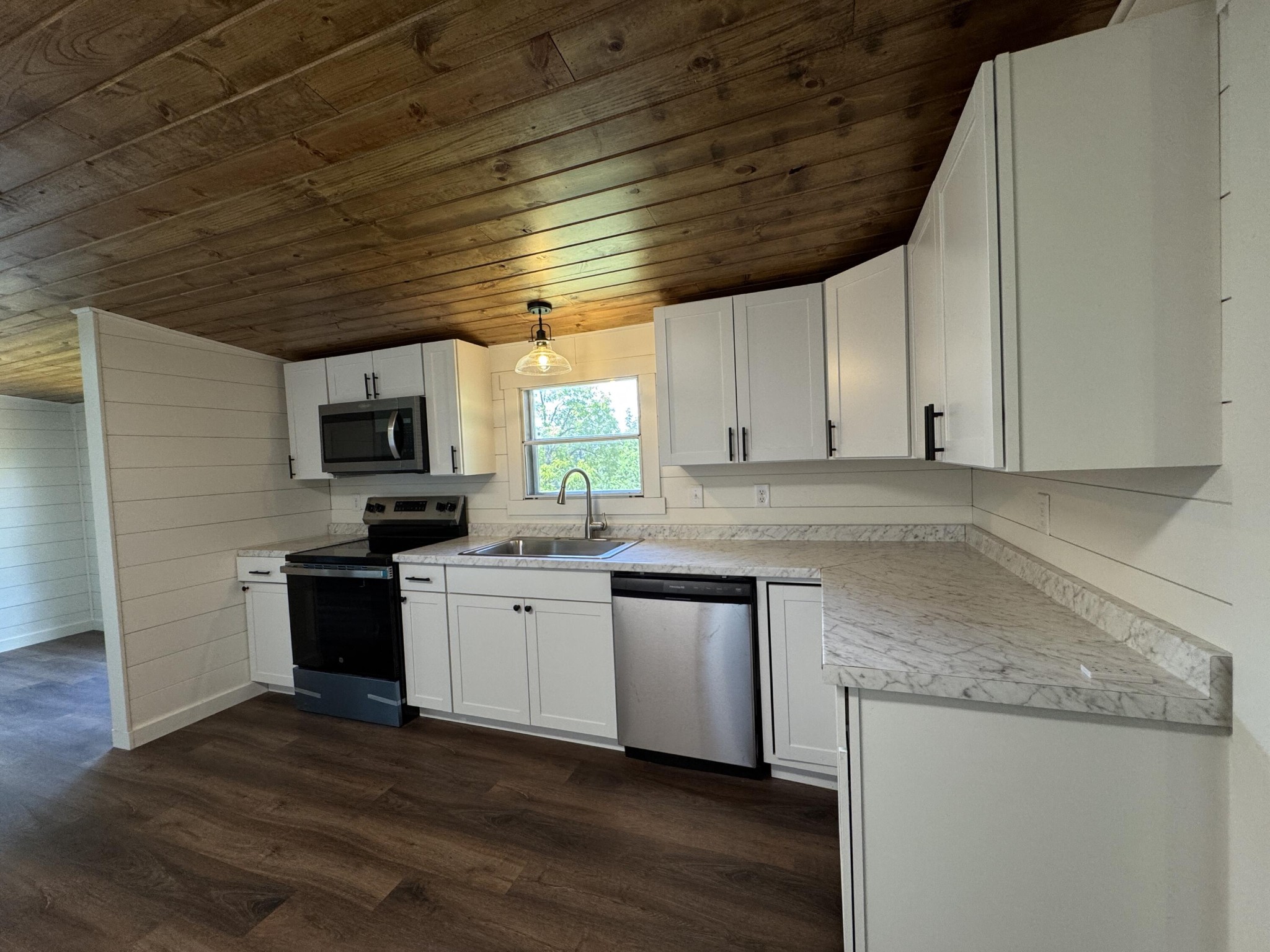 675 Ware Lane Georgetown, TN 37336 - Photo 12 of 24 a kitchen with stainless steel appliances granite countertop a sink a stove a microwave and cabinets