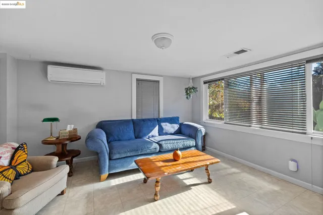 an empty room with a mirror and a window