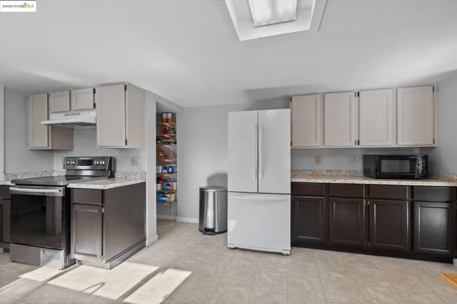 a bathroom with a granite countertop sink a mirror a and a shower