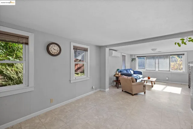 a living room with granite countertop furniture and a flat screen tv