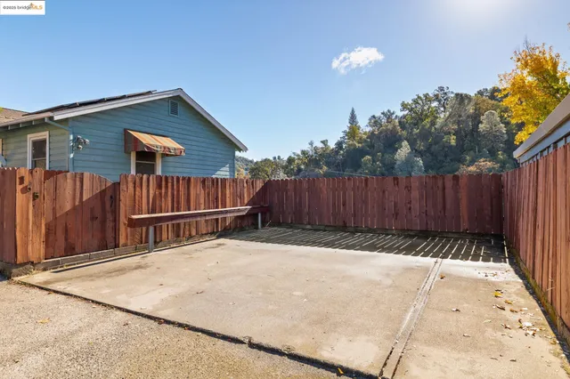 a view of a patio with a table chairs and wooden floor