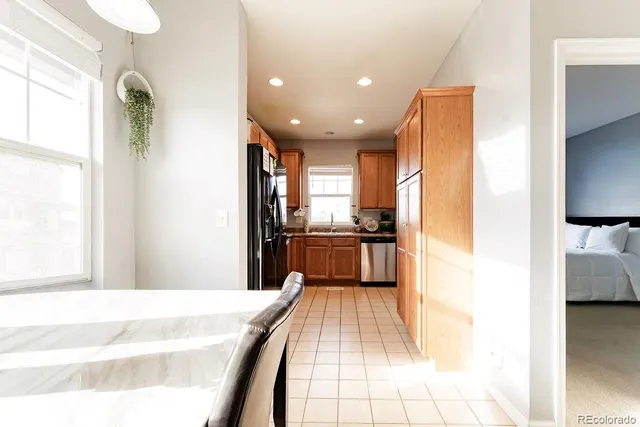 a kitchen with kitchen island a counter top space a sink and stainless steel appliances