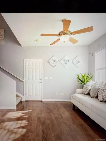 a living room with furniture and a potted plant