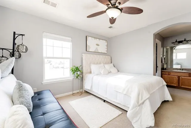 a bedroom with a large bed and a window