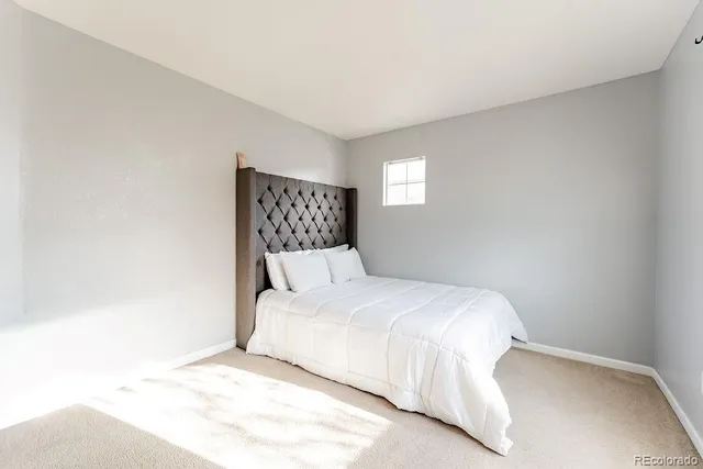 a bedroom with a bed and a night stand