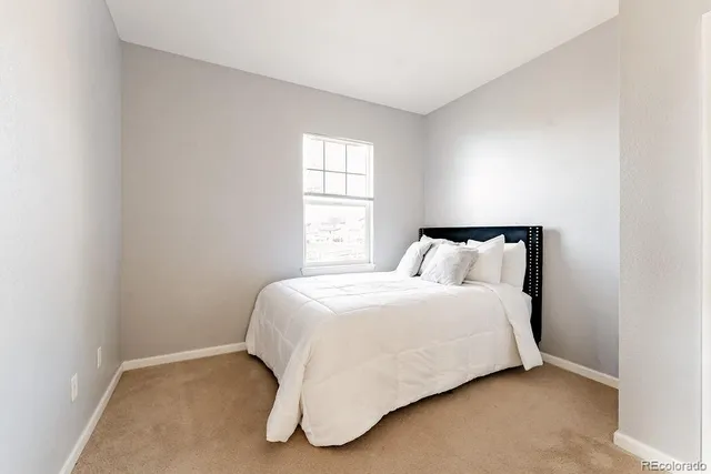 a bedroom with a bed and window