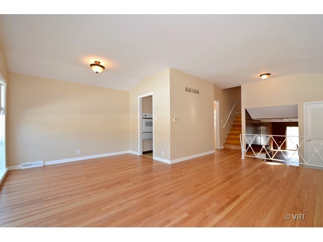 8543 East Prairie Road Skokie, IL 60076 - Photo 3 of 9 a view of a livingroom with wooden floor