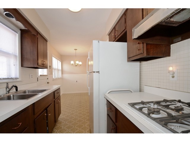 8543 East Prairie Road Skokie, IL 60076 - Photo 4 of 9 a kitchen with a sink a stove and refrigerator