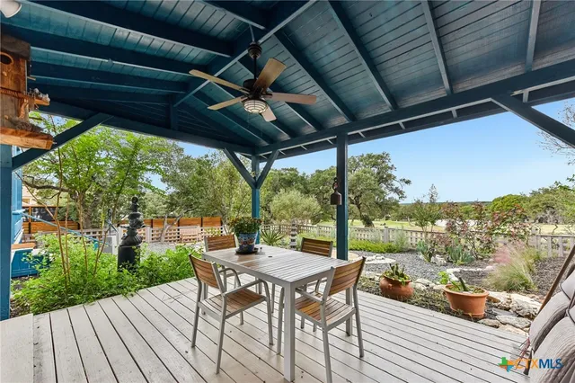 a view of a outdoor space with chairs and wooden floor